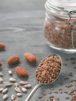 Homemade LSA mix in spoon - Linseed or flax seeds, Sunflower seeds and Almonds. Traditional Australian blend of ground, source of dietary fiber, protein, omega fatty acids. Copy space for text.