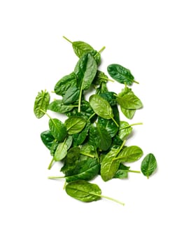 Heap of baby spinach leaves. Fresh green baby spinach isolated on white with clipping path. Top view or flat lay. Vertical.