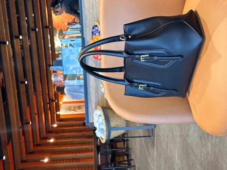 Black handbag on an armchair at the coffee shop