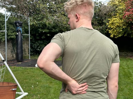 Rear view shot of a man suffering from back pain