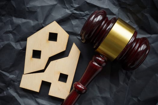 Divided house and wooden gavel. Division of real estate in case of divorce or inheritance.
