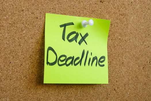 Sticker with the inscription tax deadline is pinned to the board.
