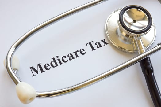 Document about Medicare tax and a stethoscope.