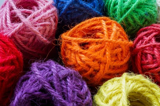 Balls of colored thick thread as abstract background for variety.