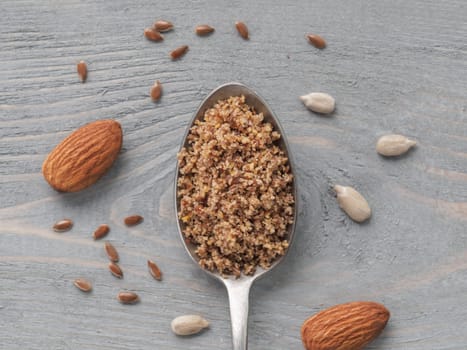 Homemade LSA mix in spoon - Linseed or flax seeds, Sunflower seeds and Almonds. Traditional Australian blend of ground, source of dietary fiber, protein, omega fatty acids. Copy space for text.