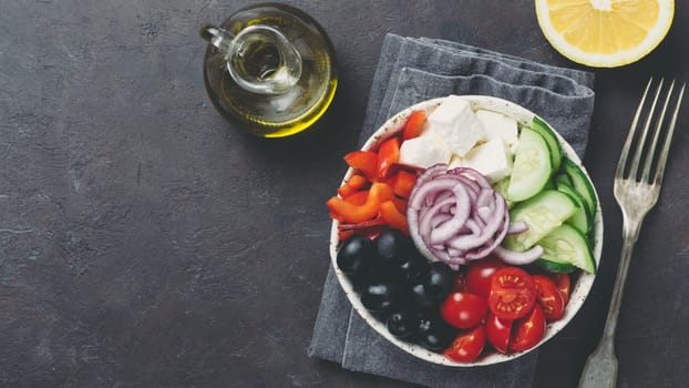 Greek Salad Bowl on dark black background, copy space. Above view of Bowl Greek Salad. Trendy food. Idea, recept and concept of modern healthy food. Banner