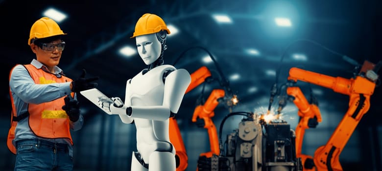 XAI Mechanized industry robot and human worker working together in future factory. Concept of artificial intelligence for industrial revolution and automation manufacturing process.