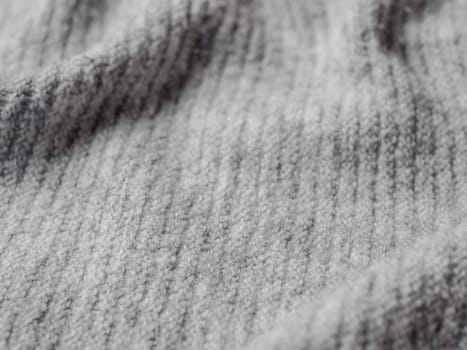 Gray sweater fabric texture. Clothes sweater background with folds