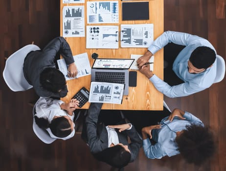 Top view multiracial analyst team use BI dashboard display on laptop screen, analyzing financial data for strategic decision. Fintech analyzes marketing indicators. Concord