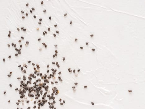 Chia seeds with copy space. Chia seed on white concrete textured background. Top view or flat lay. Copy space. Healthy food and diet concept