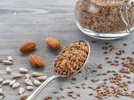 Homemade LSA mix in spoon - Linseed or flax seeds, Sunflower seeds and Almonds. Traditional Australian blend of ground, source of dietary fiber, protein, omega fatty acids. Copy space for text.