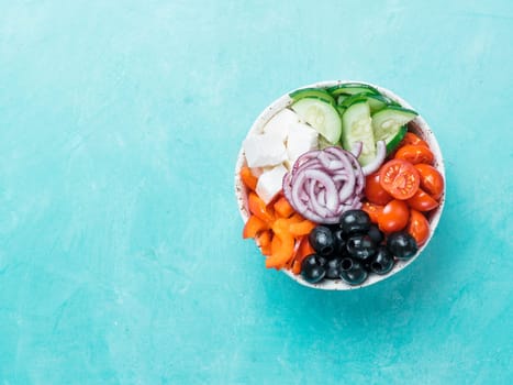 Greek Salad Bowl on blue background, copy space. Above view of Bowl Greek Salad. Trendy food. Idea, recept and concept of modern healthy food. Banner