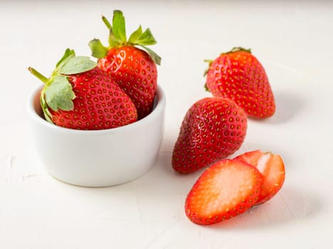 Fresh ripe strawberries in small white bowl. Strawberry in bowl on oriental white background