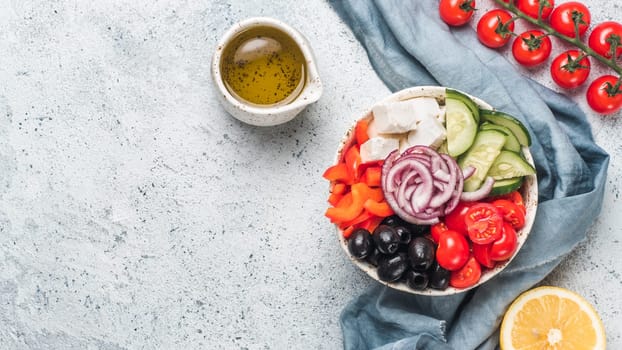 Greek Salad Bowl on gray cement background, copy space. Above view of Bowl Greek Salad. Trendy food. Idea, recept and concept of modern healthy food. Banner.