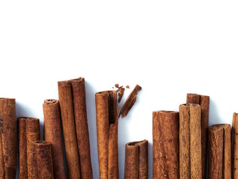 Cinnamon sticks isolated on white with copy space. Top view or flat lay