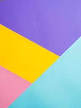 Colorful colored paper background. Multicolor blue, yellow, pink, lilac background. Copy space for text. Abstract pattern can use for design, wallpaper