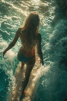 A young girl in a bikini is a surfer with a surfboard, floating on the waves.
