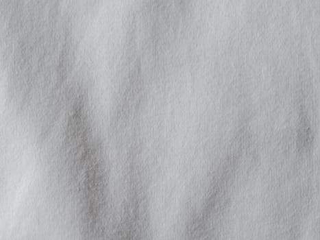 White cotton fabric texture. Clothes cotton jersey background with folds