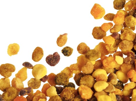 Extreme closeup view of bee pollen on white background. Isolated one edge. Copy space. Top view or flat lay.