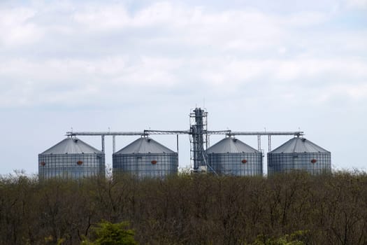 industrial grain silos for agriculture in a rural landscape.