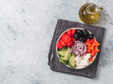 Greek Salad Bowl on gray cement background, copy space. Above view of Bowl Greek Salad. Trendy food. Idea, recept and concept of modern healthy food.