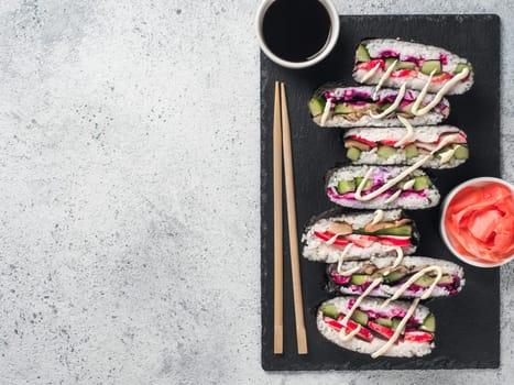 Vegan sushi sandwich onigirazu with mushrooms and vegetables.Healthy dinner recipe and idea. Colorful japan sandwich onigirazu with red cabbage,radish,cucumber,mushrooms.Trend food.Copy space.Top view