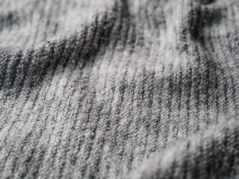 Gray sweater fabric texture. Clothes sweater background with folds