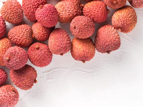 lichee fruit on white textured background. Lychee wit copy space. Top view or flat lay.