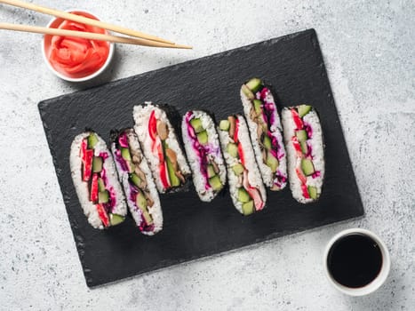 Vegan sushi sandwich onigirazu with mushrooms and vegetables. Healthy dinner recipe and idea. Colorful japan sandwich onigirazu with red cabbage,radish,cucumber,mushrooms. Trend food. Top view