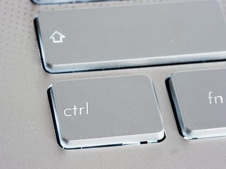Ctrl - Control key on silver laptop keyboard. Close up