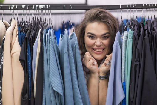 Smiling fat woman in plus size store looking at camera