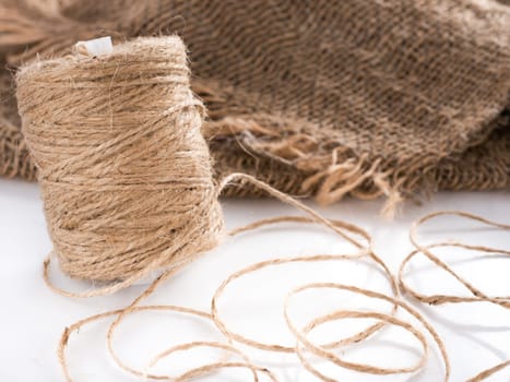 Skein of jute twine. Clew of natural rope. Roll of twine jute on sacking