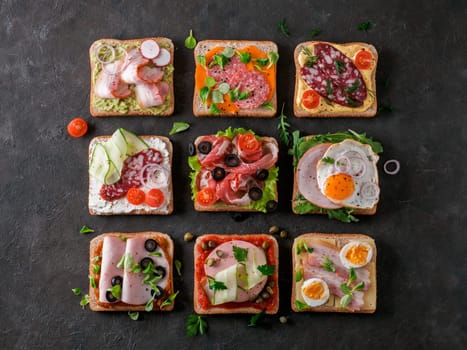 Set of eight different sandwiches with meat in square shape. Top view or flat lay. Assortment meat toasts on black background. Idea, creative concept for sausage maker