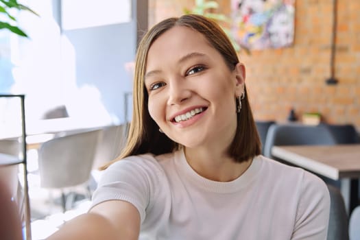 Close up selfie portrait of young smiling attractive beautiful woman. Beauty, fashion, youth, lifestyle concept