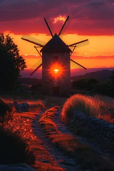 Traditional Windmill Silhouetted Against a Setting Sun, The sails blur with the sky, the romance of history outlined in twilight.