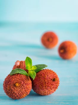 lichee fruit on turquoise wooden background close up