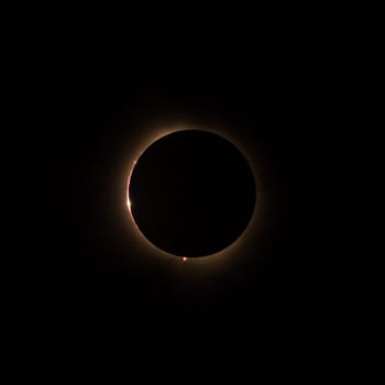 HD image of the solar eclipse in 2024 with the moon finally covering the sun. Baily's beads of light seen through canyons on the moon