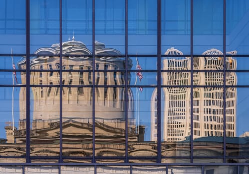 Reflection of the Ohio state Capitol building in the windows of an office building across the street in Columbus, OH