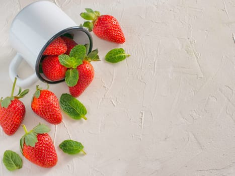 Fresh red strawberries in metal cup. Strawberry in rustic cup on oriental white background. Top view or flat lay