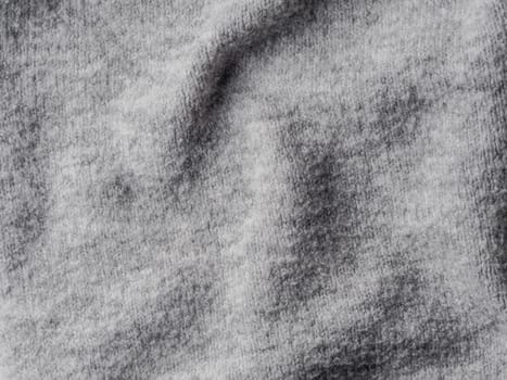 Gray sweater fabric texture. Clothes sweater background with folds