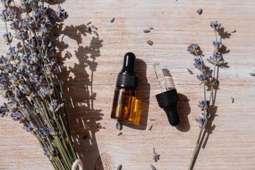 Dried lavender flowers with glass dropper of natural essential oil. Organic herbal aromatherapy healthy glass bottle. Home fragrance extract. Beauty care