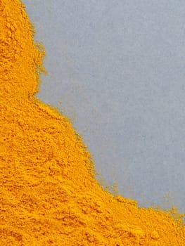 Turmeric Powder or Curcuma longa on gray background. Top view. Copy space for text.