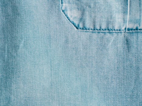 Modern soft jeans blouse with breast pocket texture close up. Lyocell or tencel pattern - modern natural cellulose fabric blue denim color. Can use for design or text. Copy space