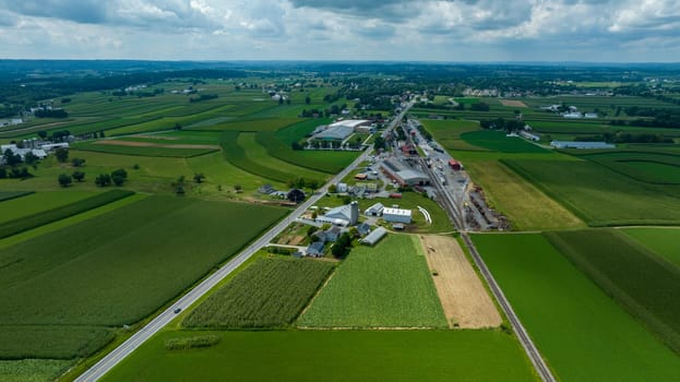 This image captures the essence of rural life, where a small town seamlessly integrates with the surrounding vibrant green farmlands.