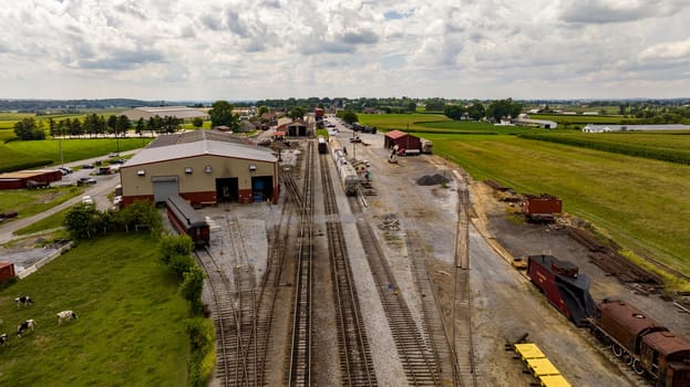 Strasburg, Pennsylvania, August 15, 2023 - The heart of agricultural logistics beats in this rustic rail depot, where a series of tracks and trains intermingle with the vast expanse of farmlands.