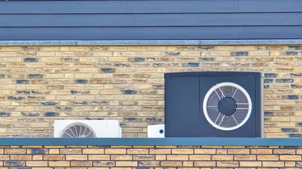 air source heat pump unit installed outdoors at a modern home with bricks in the Netherlands at spring, warmte pomp translation air source heat pump , airco and heat pump