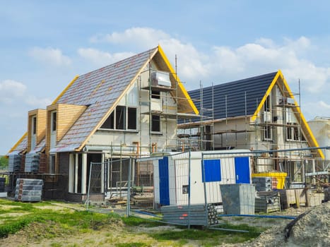 construction site of a new Dutch Suburban area with modern family houses, newly built modern family homes in the Netherlands on a sunny day