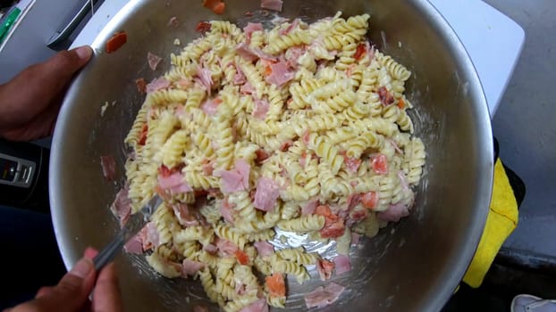 Pasta spaghetti with cream cheese sauce and small pieces of ham