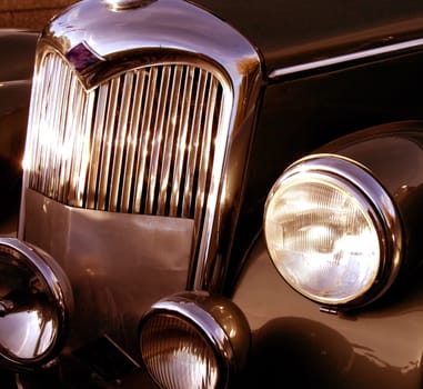 The front grill and headlight of the old beautiful car on the background copy space, card background, multimedia content creation
