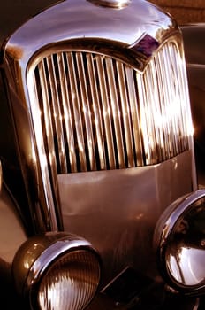 The front grill and headlight of the old beautiful car on the background copy space, card background, multimedia content creation